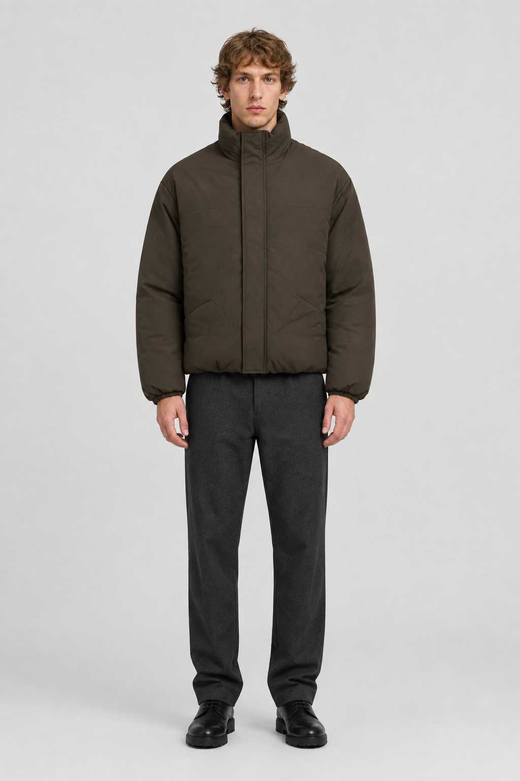 Mannelijk model met de donkerbruine Only & Sons Puffer Jas Josh met hoge kraag, volledig van voren gefotografeerd